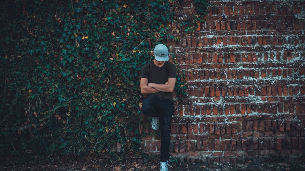 young man against a brick wall