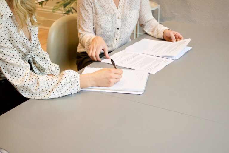 young professional women reading documents