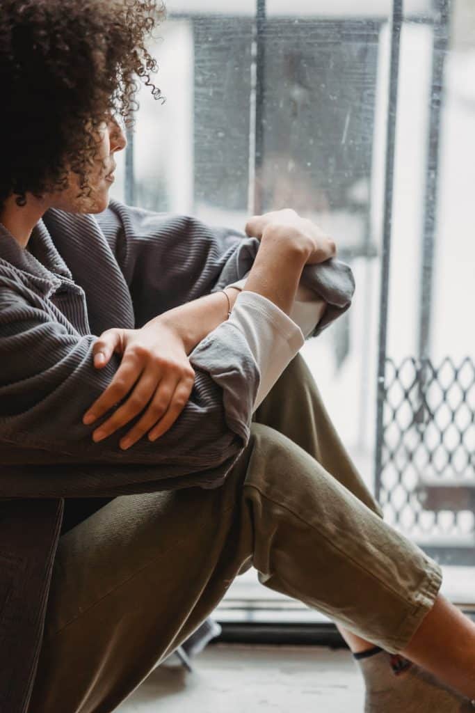 young woman looking out on a rainy day