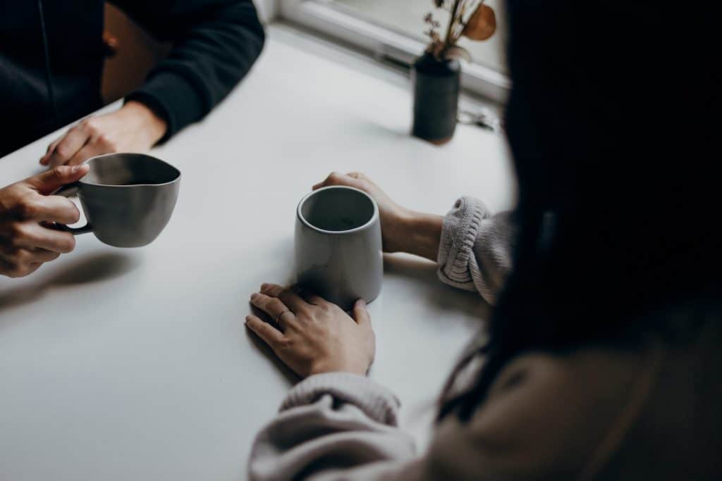 girls sharing conversation over a cup of coffee